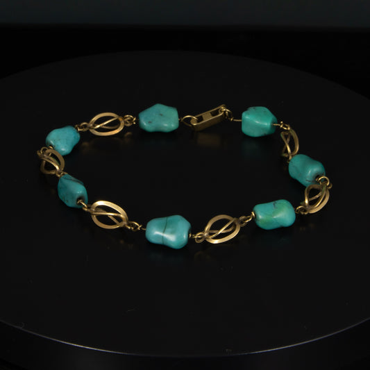 Pulsera en oro amarillo y turquesas.