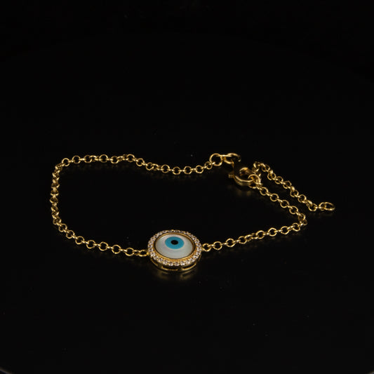 Pulsera en oro amarillo con ojo turco, diamantes y madre perla.