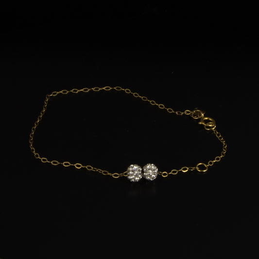 Pulsera en oro amarillo con bolitas moviles de diamantes.