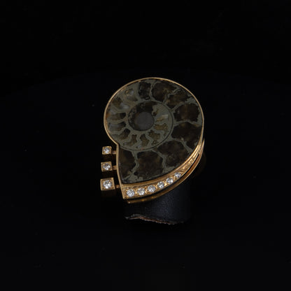 Anillo en oro amarillo con gema fosilizada y brillantes.