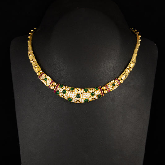 Gargantilla en oro amarillo,  diamantes talla brillantes, rubís talla princesa y cabujones de esmeraldas estilo Bulgari.. Años 80.
