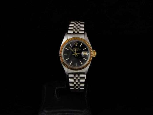 Rolex Lady-Datejust en acero con bisel de oro amarillo y correa jubilee, esfera negra. 26 mm. Año 1970