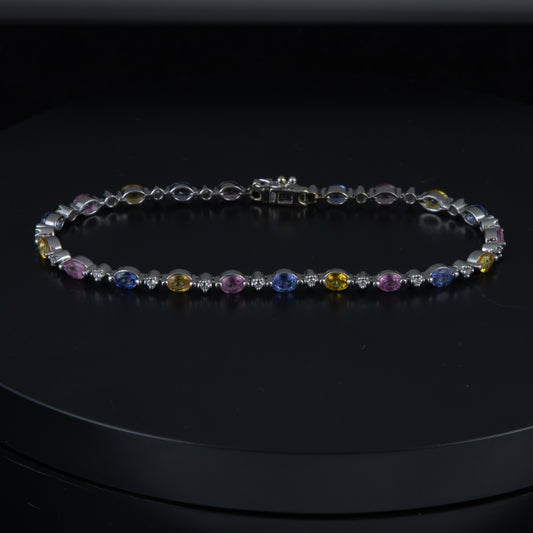 Riviere oro blanco, diamantes, y topacios de colores.